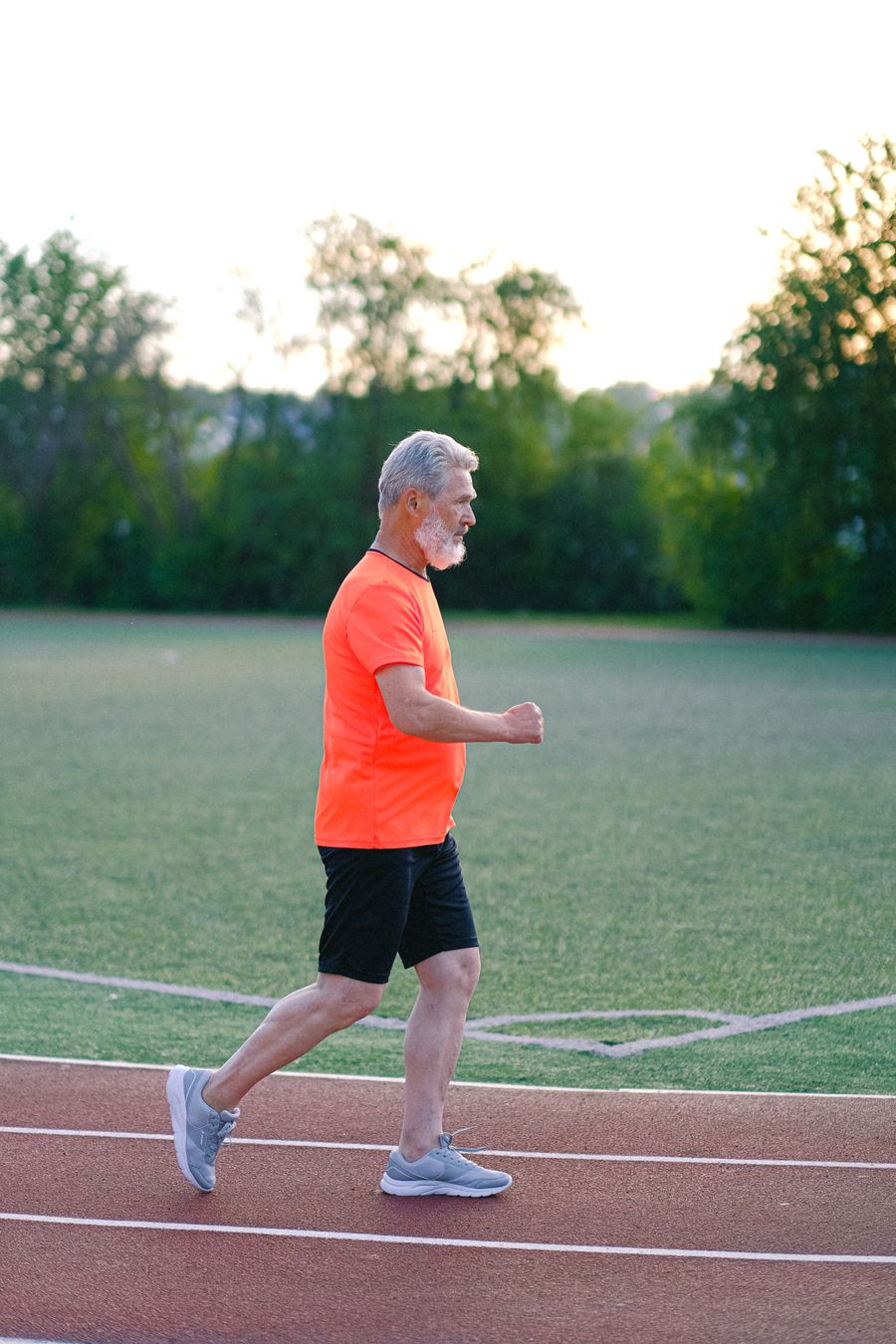 Active man jogging on a track — men's health and vitality