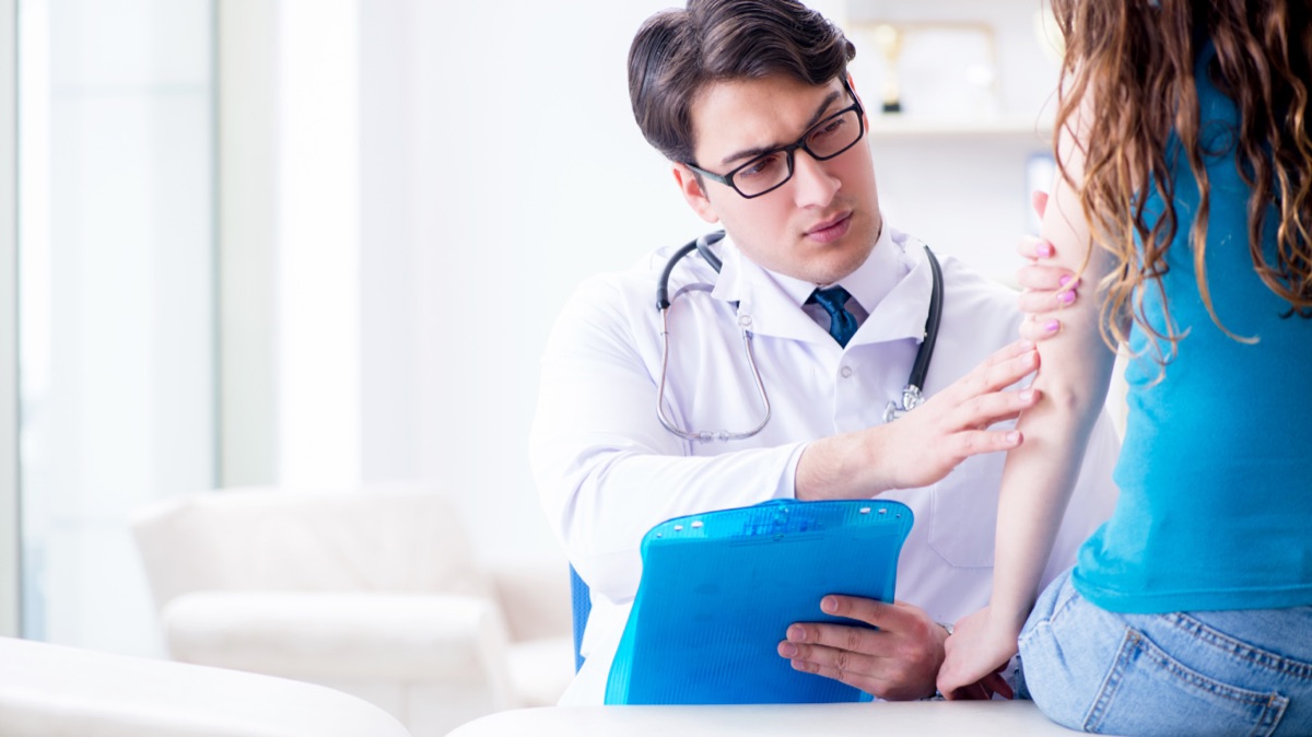 Physician performing a comprehensive physical exam